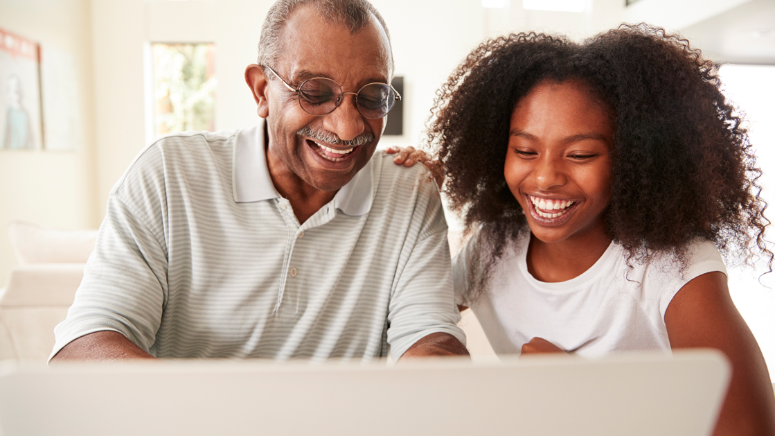 Happy couple in front of laptop